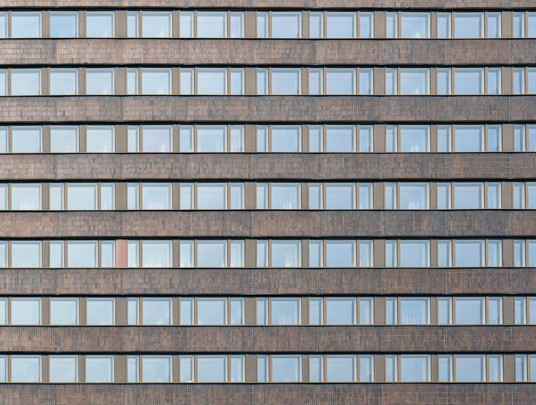A dense, repeating grid of windows across a tall hotel facade.